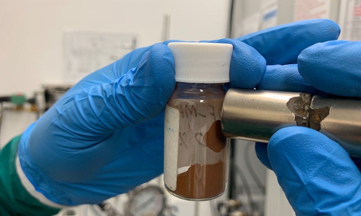 A magnet attracts the material that the team used to make adsorbents that remove microplastics and dissolved pollutants from water